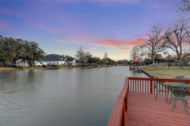 view of dock featuring fence and a water view