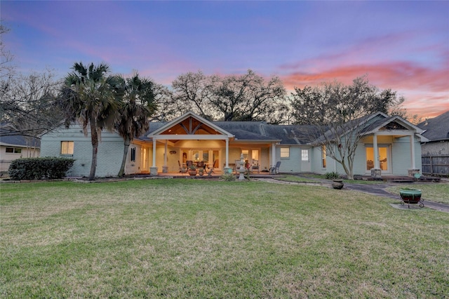 view of front of property with brick siding and a front yard