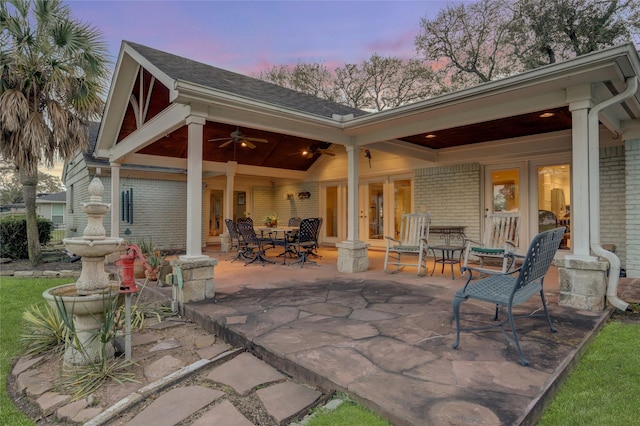 patio terrace at dusk featuring ceiling fan