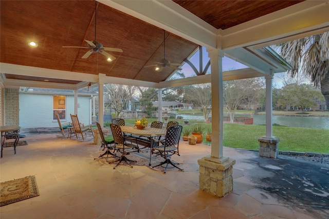 view of patio / terrace with outdoor dining space, a ceiling fan, and a water view