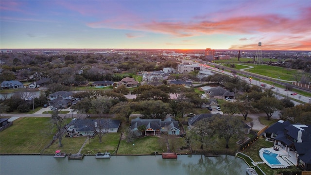 drone / aerial view featuring a residential view and a water view