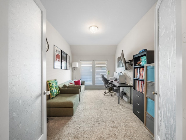 home office with vaulted ceiling and carpet flooring