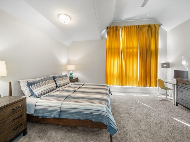 carpeted bedroom featuring vaulted ceiling