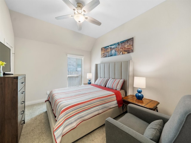 carpeted bedroom featuring vaulted ceiling, a ceiling fan, and baseboards