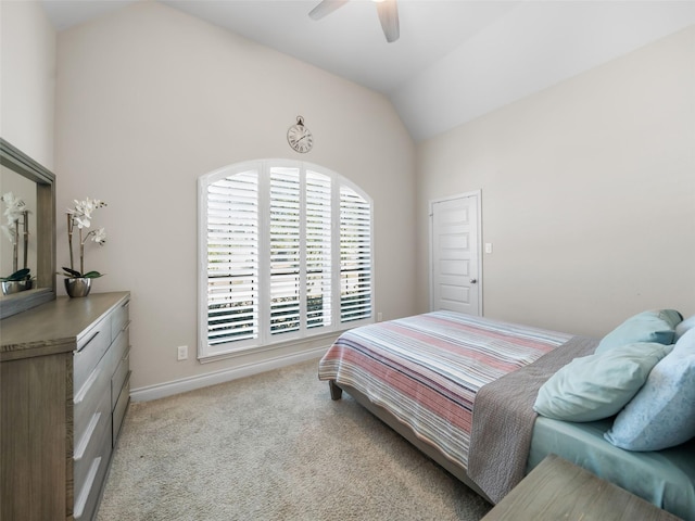 carpeted bedroom with lofted ceiling, baseboards, and a ceiling fan