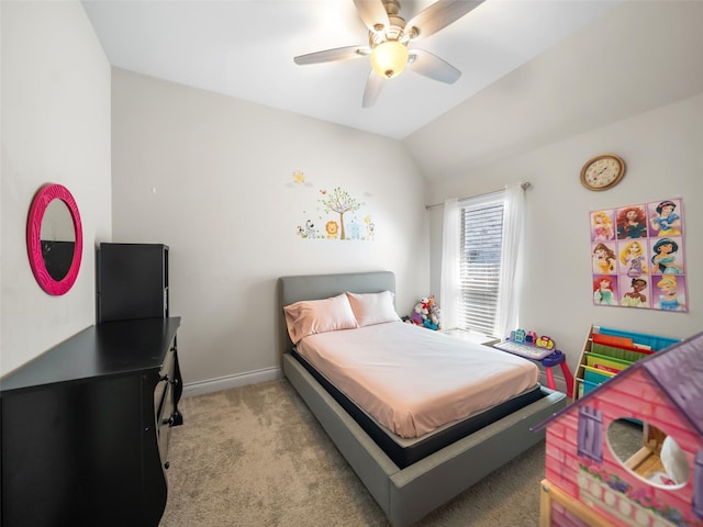 bedroom with light colored carpet, vaulted ceiling, baseboards, and ceiling fan