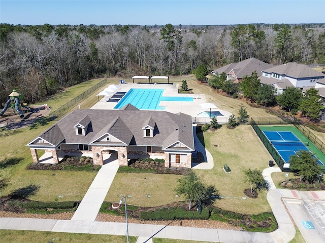 drone / aerial view with a wooded view