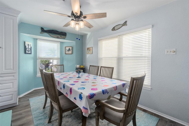 dining space featuring ceiling fan, baseboards, and wood finished floors