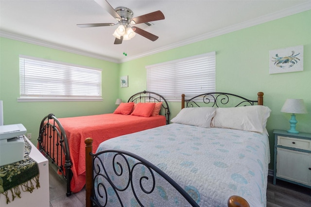 bedroom featuring crown molding, ceiling fan, and wood finished floors