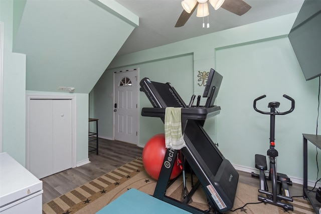 exercise room featuring ceiling fan, baseboards, lofted ceiling, and wood finished floors