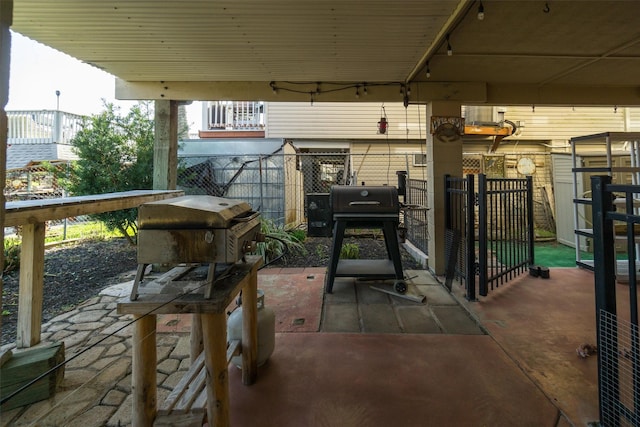 view of patio with a grill and fence