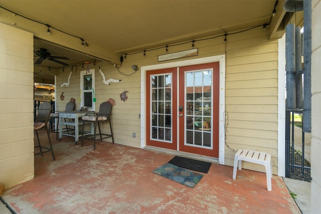 doorway to property featuring french doors, a patio, and a ceiling fan