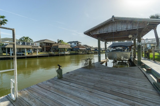 dock area with a water view and boat lift