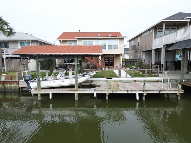 dock area featuring a water view, a patio, and fence