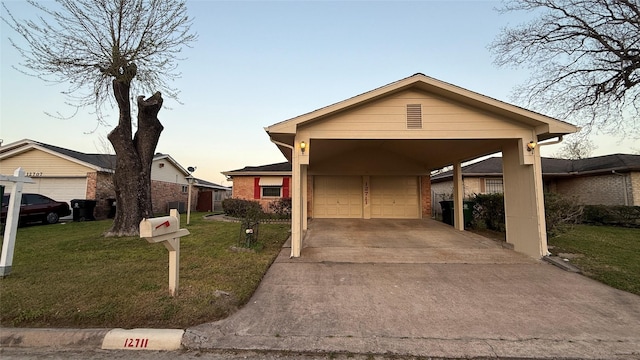 ranch-style house with a carport, a garage, brick siding, and a front yard