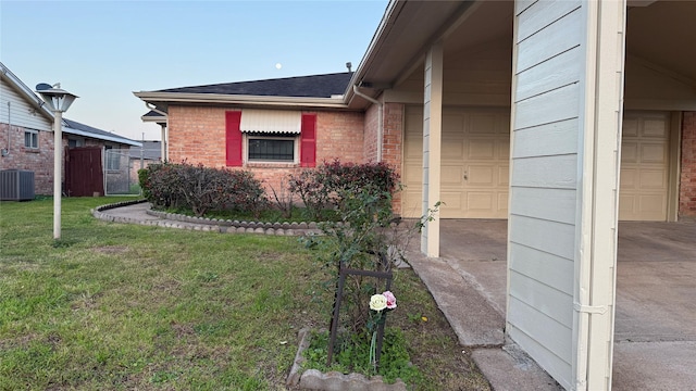 view of property exterior with brick siding, a shingled roof, fence, central AC unit, and a yard