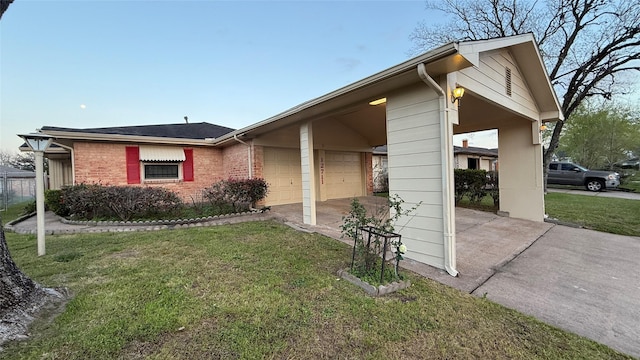 view of front of home featuring brick siding, an attached garage, concrete driveway, and a front yard