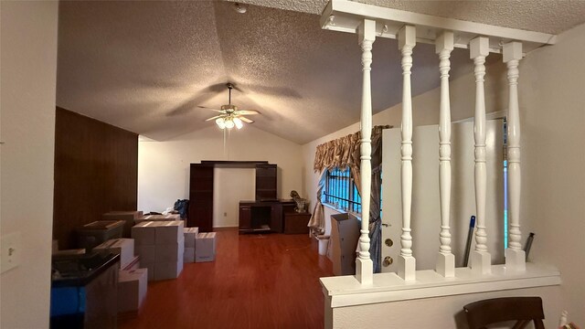 interior space with lofted ceiling, wood finished floors, and a textured ceiling