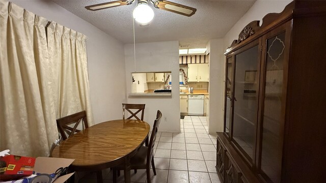 dining space with light tile patterned flooring, a ceiling fan, and a textured ceiling