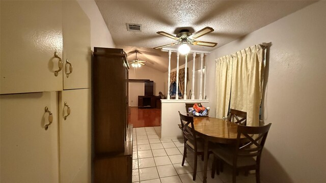 dining room featuring light tile patterned floors, visible vents, a textured ceiling, and ceiling fan