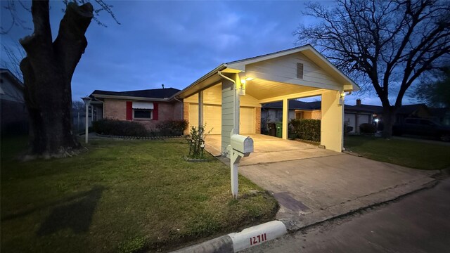 view of front of property featuring an attached garage, concrete driveway, and a front yard