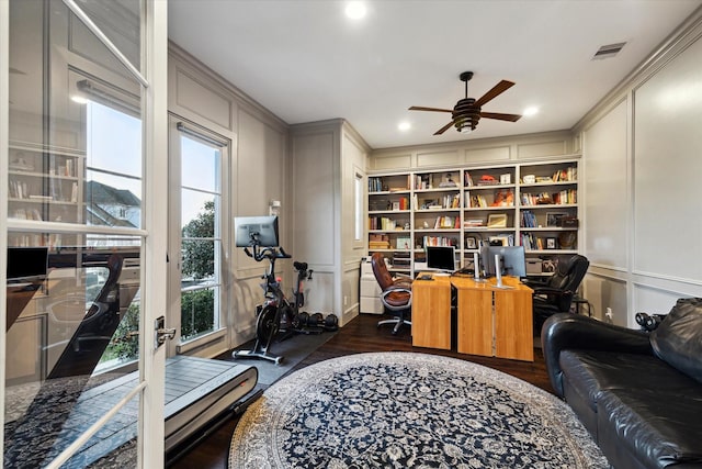 office featuring visible vents, a ceiling fan, wood finished floors, recessed lighting, and a decorative wall