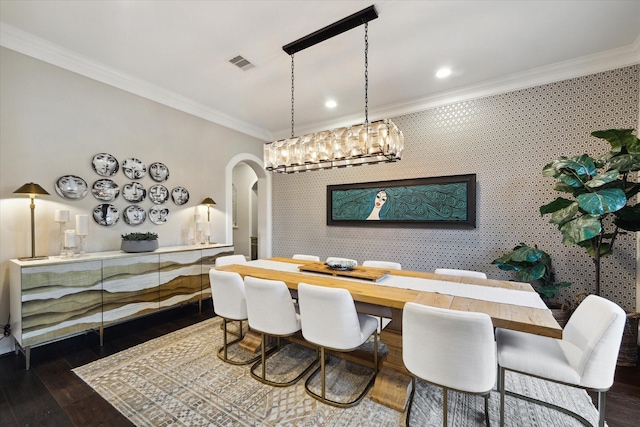 dining room featuring visible vents, arched walkways, ornamental molding, and wallpapered walls