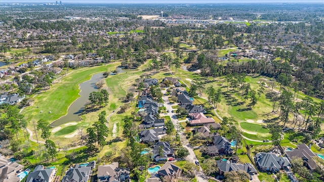 drone / aerial view with a residential view, a water view, and view of golf course