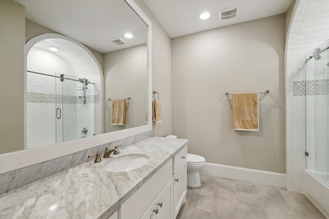 bathroom featuring vanity, toilet, baseboards, and visible vents