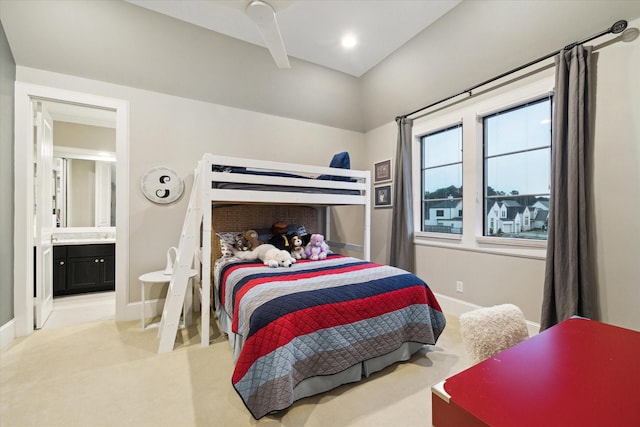 bedroom with light carpet, recessed lighting, ensuite bath, and baseboards