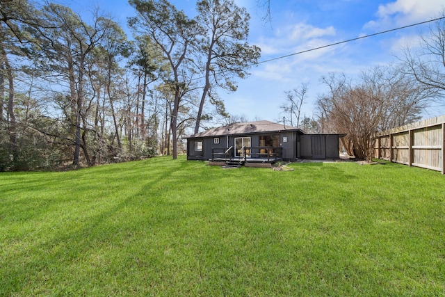 view of yard with fence and a wooden deck