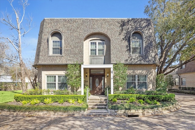 view of front property with roof with shingles