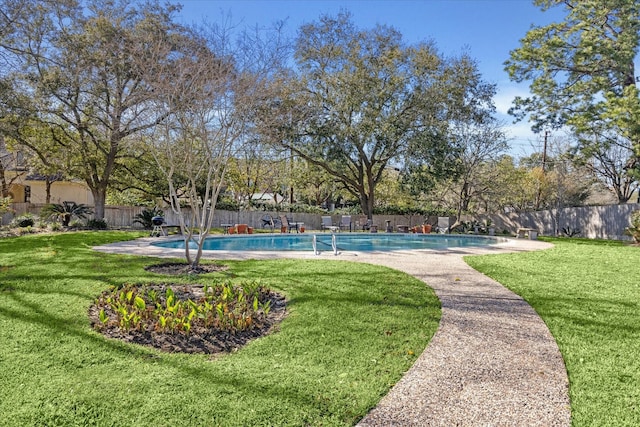 view of swimming pool featuring a lawn, a patio, a fenced backyard, and a fenced in pool