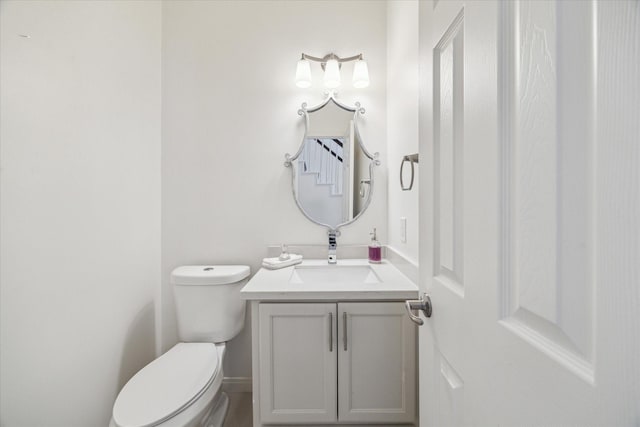 half bathroom with vanity and toilet