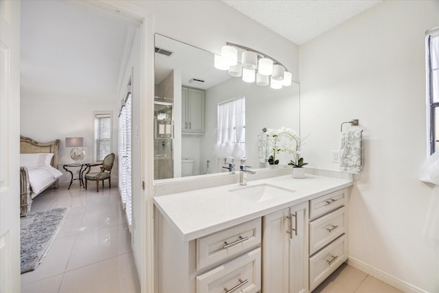 full bathroom with visible vents, a stall shower, ensuite bathroom, tile patterned flooring, and vanity