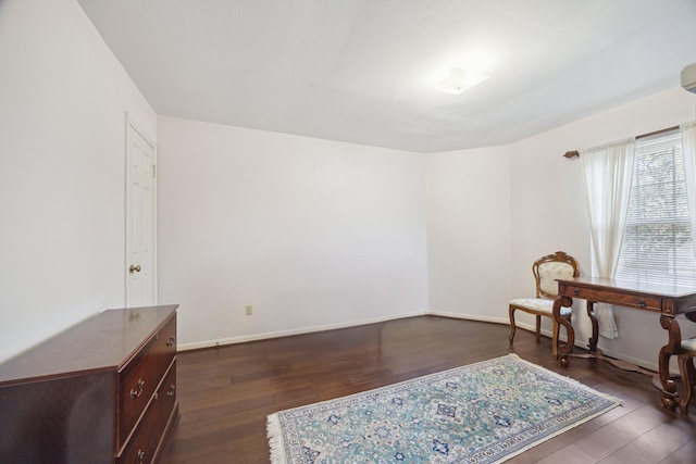 sitting room featuring dark wood-type flooring and baseboards