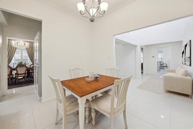 dining space featuring crown molding, a notable chandelier, and light tile patterned floors