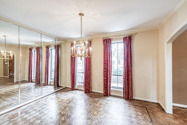 unfurnished dining area featuring a chandelier, ornamental molding, and baseboards