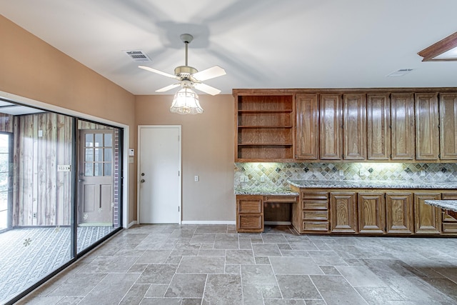 kitchen with open shelves, stone finish flooring, visible vents, and decorative backsplash