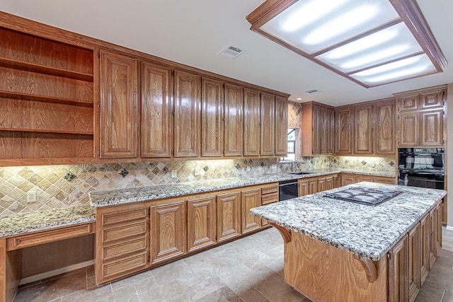 kitchen with light stone counters, visible vents, black appliances, and open shelves