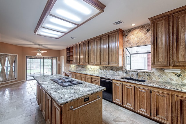 kitchen featuring a kitchen island, stone tile flooring, black appliances, open shelves, and a sink