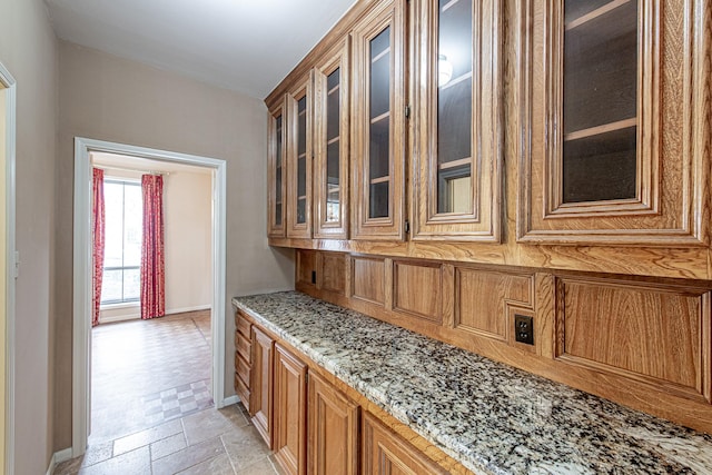 interior space with baseboards and stone tile floors