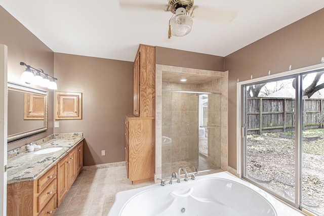 bathroom featuring tile patterned flooring, vanity, a ceiling fan, a jetted tub, and a stall shower