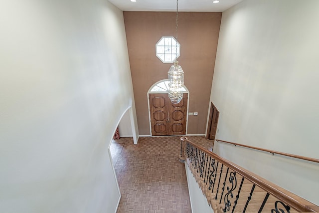 doorway featuring a high ceiling, baseboards, and recessed lighting