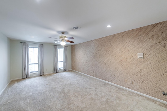 spare room with recessed lighting, visible vents, light carpet, and baseboards