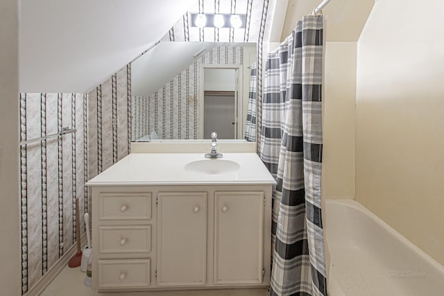 full bath featuring a shower with curtain, vanity, and wallpapered walls