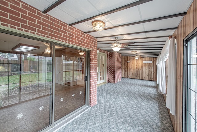 unfurnished sunroom with a ceiling fan