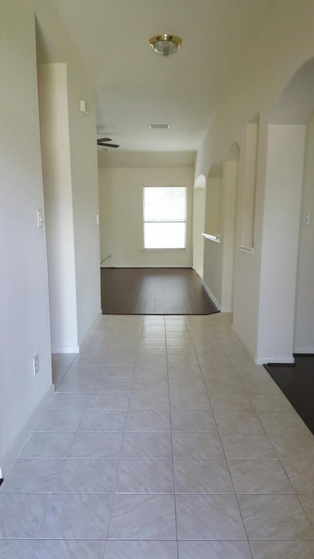 hall with tile patterned flooring and visible vents