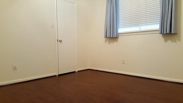 unfurnished room featuring baseboards