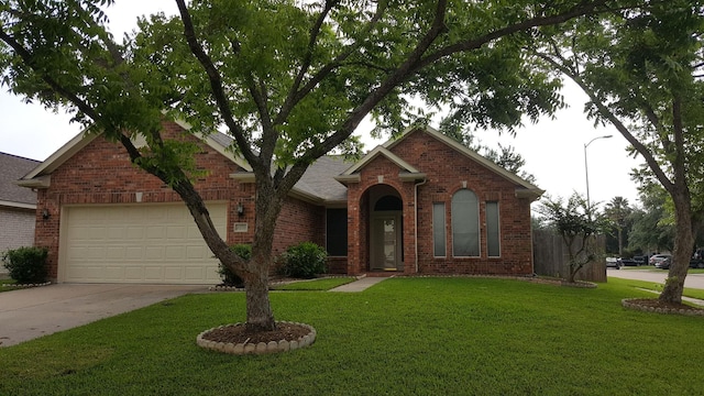 view of front of property featuring a garage, concrete driveway, brick siding, and a front lawn